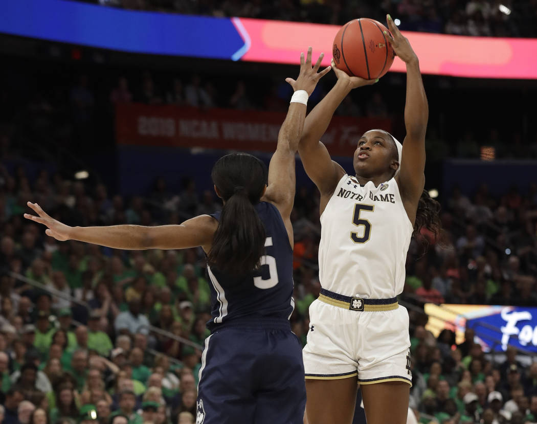 Notre Dame guard Jackie Young shoots over Connecticut guard Crystal Dangerfield during the firs ...
