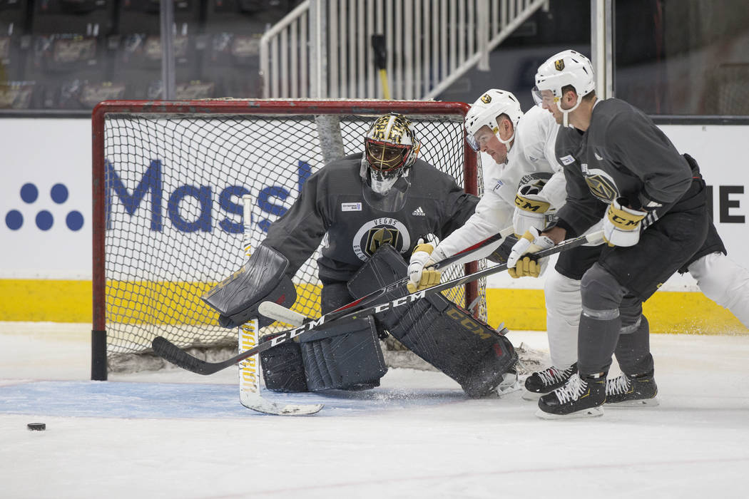 Golden Knights goaltender Malcolm Subban (30) makes a save against center Ryan Carpenter (40) w ...