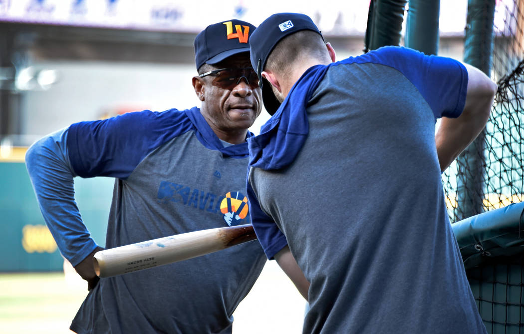 Retired Major League baseball player and now special coach Rickey Henderson, left, works with L ...