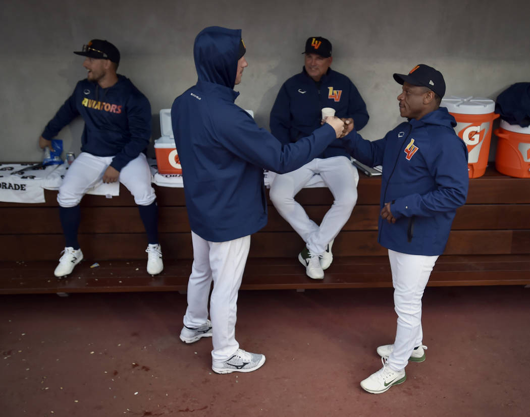 Retired Major League baseball player and now special coach Rickey Henderson, right, fist bumps ...