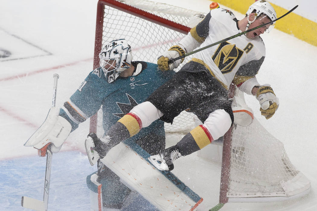 Golden Knights right wing Reilly Smith (19) collides with San Jose Sharks goaltender Martin Jon ...