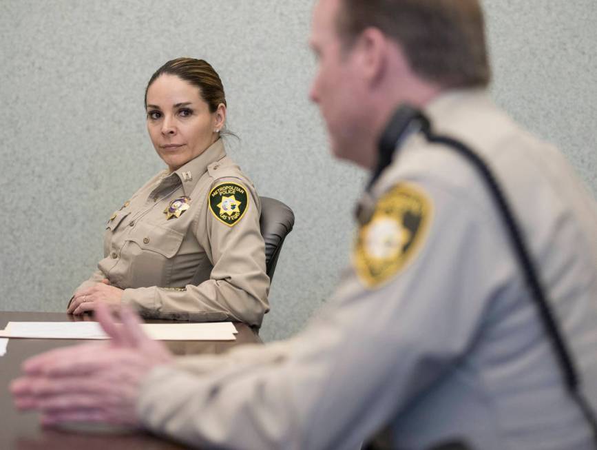 Metropolitan Police Department Capt. Sasha Larkin, left, listens to Metropolitan Police Departm ...