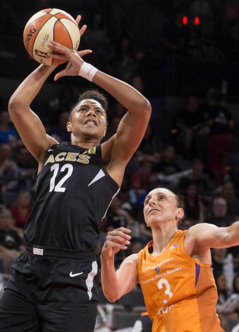 Aces forward Nia Coffey (12) gets fouled by Phoenix Mercury guard Diana Taurasi (3) in the seco ...