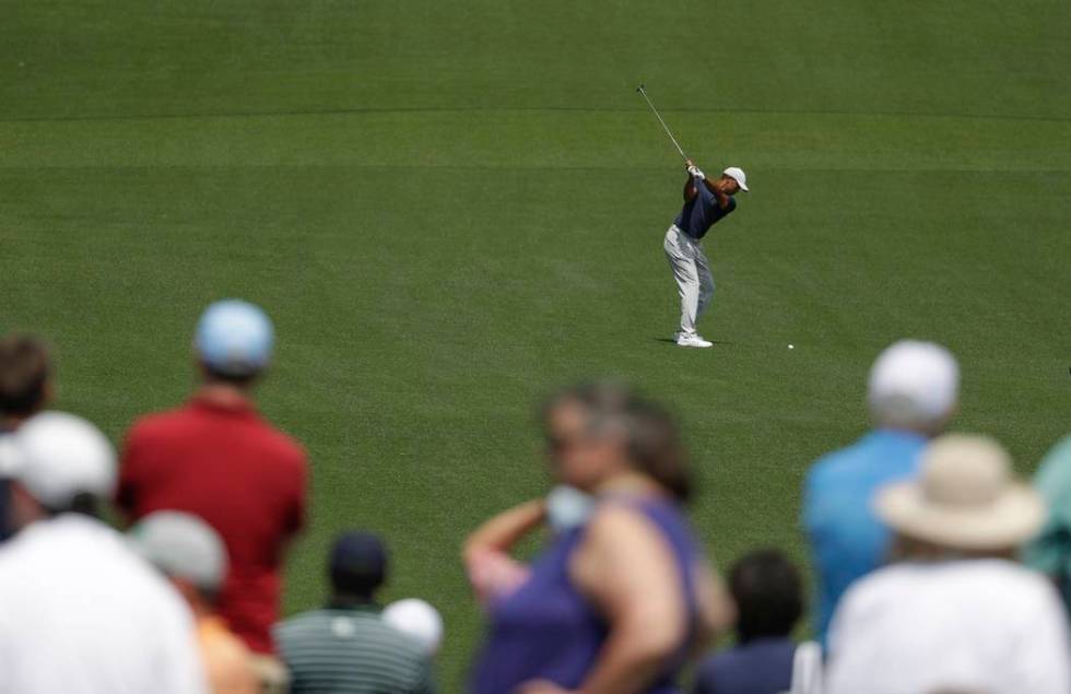 Tiger Woods hits on the eighth hole during the first round for the Masters golf tournament Thur ...