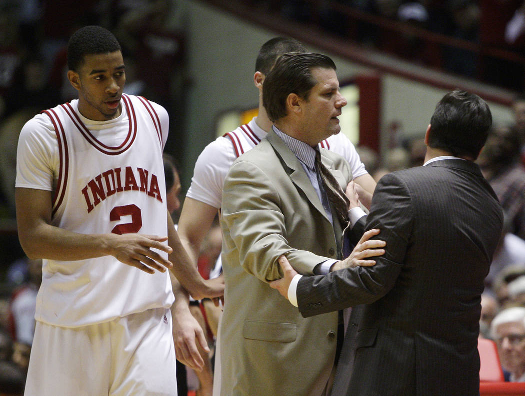 Indiana assistant Tim Buckley hold back head coach Tom Crean, after Crean received his second t ...