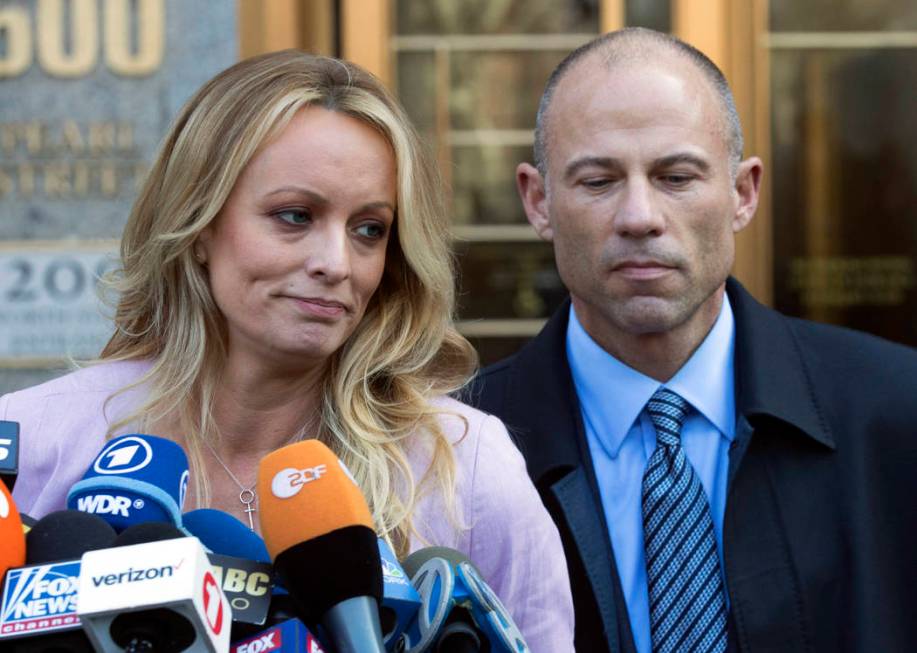 Stormy Daniels, left, stands with her lawyer Michael Avenatti as she speaks outside federal cou ...