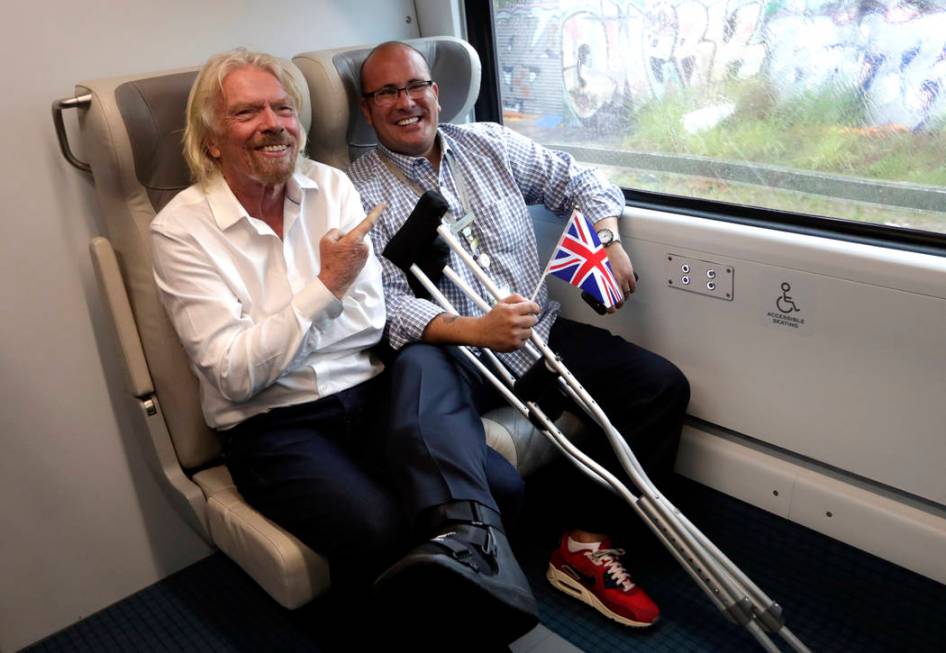 Richard Branson, of Virgin Group, left, sits with a passenger while riding a Brightline train f ...