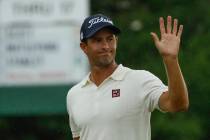 Adam Scott, of Australia, waves as he walks off the 18th green during the second round for the ...