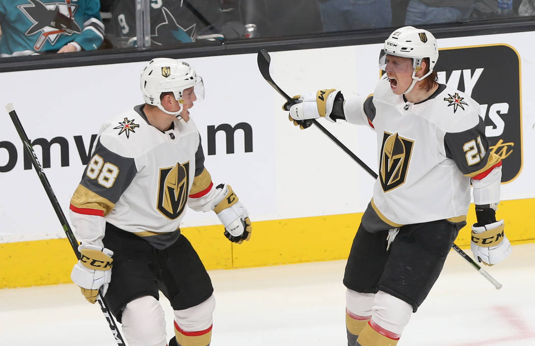 Golden Knights center Cody Eakin (21) celebrates with teammate Nate Schmidt (88) after scoring ...