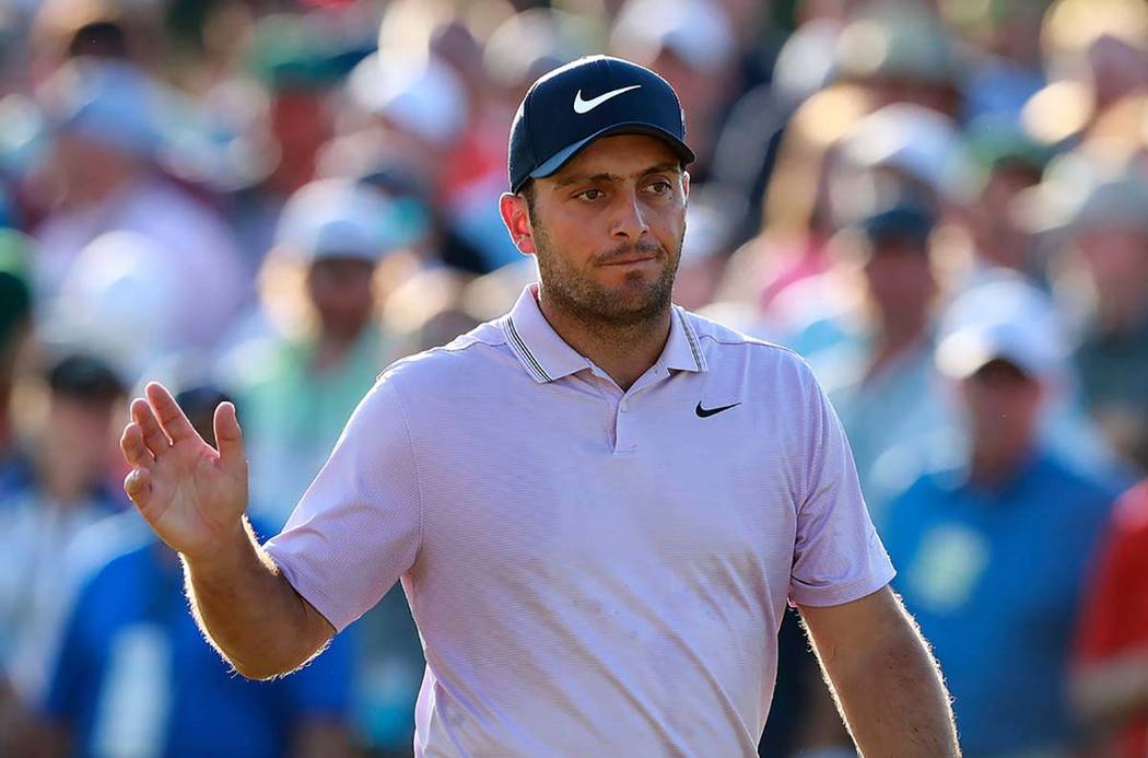 Francesco Molinari waves on the 18th green making a par to finish at 13 under for the lead in t ...