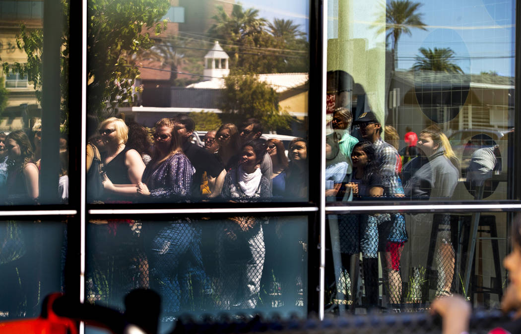 Many patrons reflected in the glass join in on the celebrations during the launch of The Lucy a ...