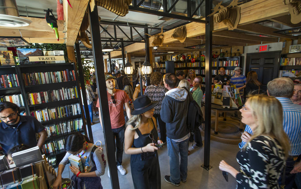 Guests explore all the new sections, books and merchandise for sale during the grand opening of ...