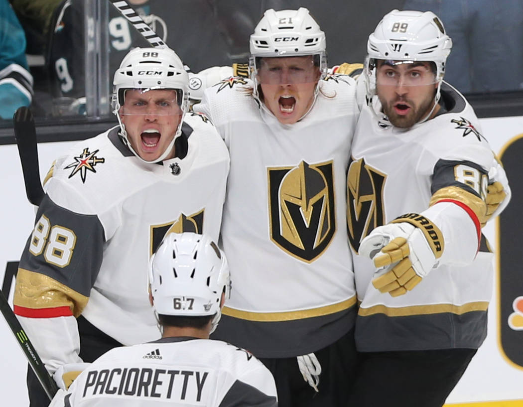 Golden Knights center Cody Eakin (21) celebrates with teammates Nate Schmidt (88), Alex Tuch (8 ...