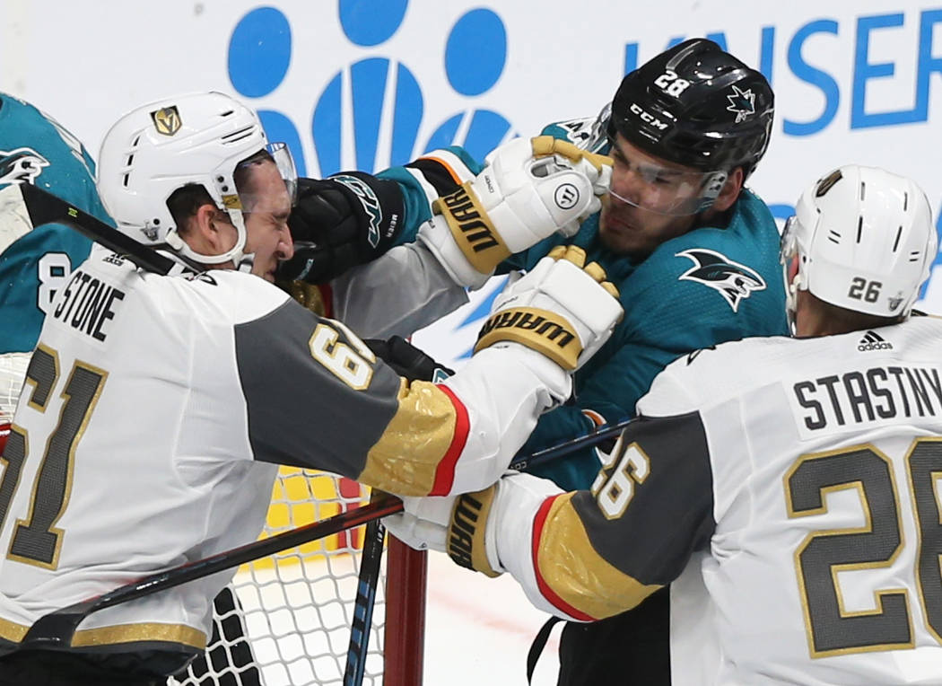 Golden Knights right wing Mark Stone (61) fights San Jose Sharks right wing Timo Meier (28) in ...