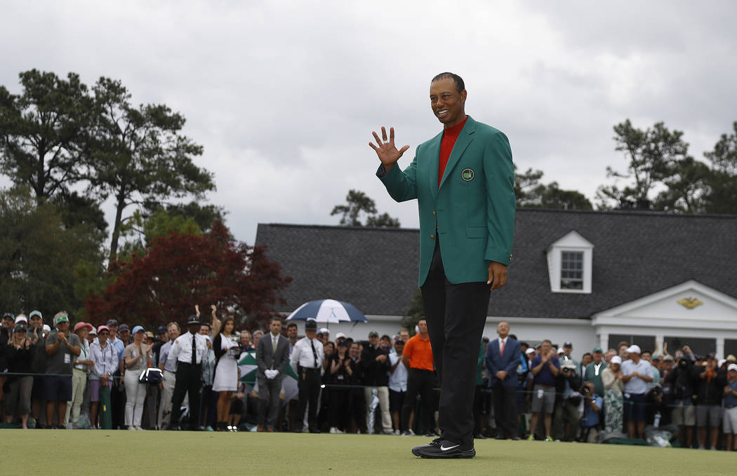 Tiger Woods wears his green jacket after winning the Masters golf tournament Sunday, April 14, ...