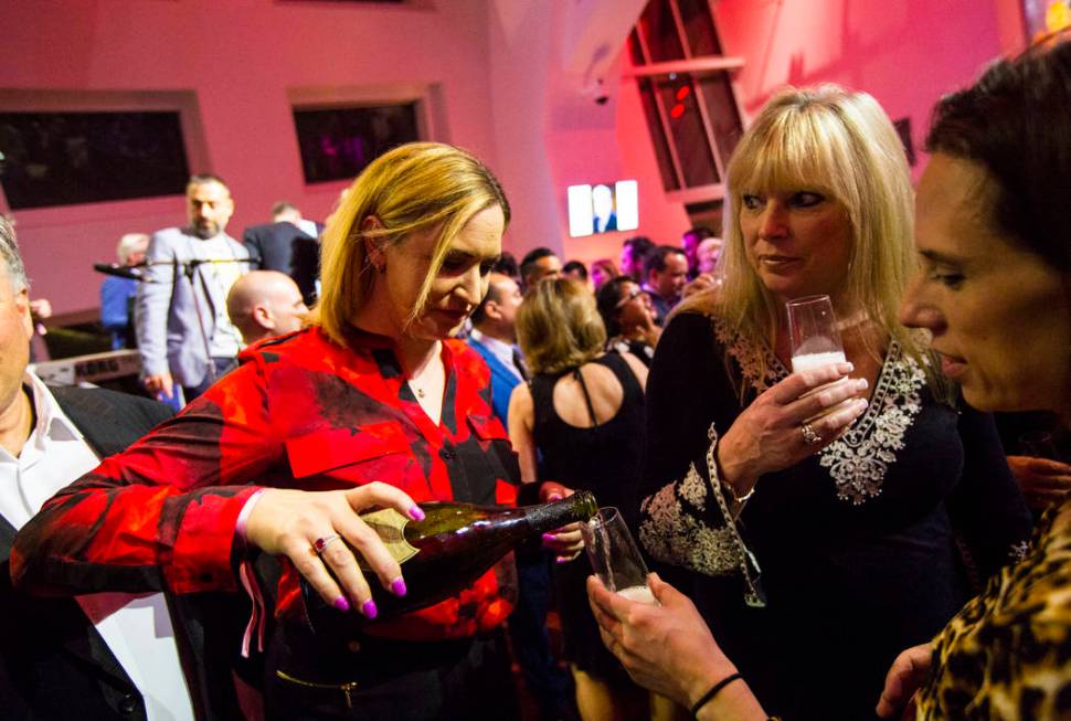 Kristin Seifert, left, pours Dom Perignon for attendees during Bubble-Licious, the UNLVino kick ...