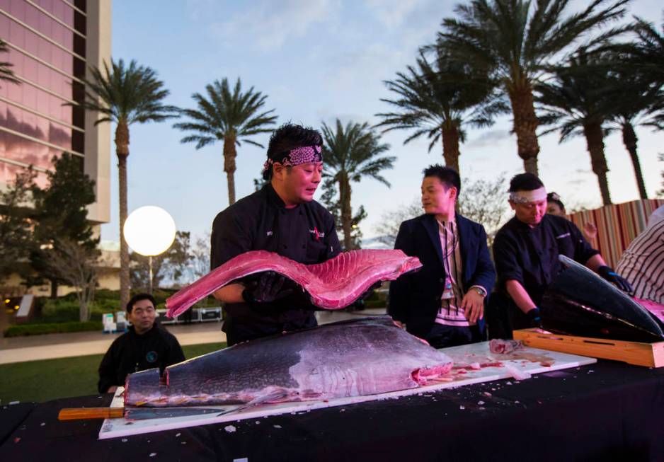 Naked Fish Executive Chef Ryusuke Ikai holds up a piece of bluefin tuna weighing nearly 300 pou ...