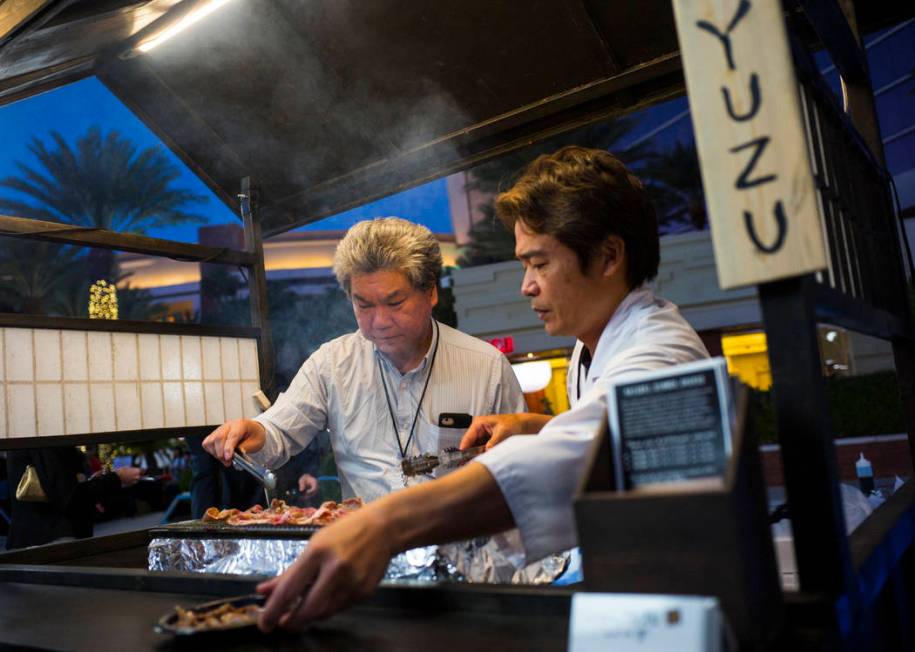 Chef Kaoru ÒAzeÓ Azeuchi of Kaiseki Yuzu prepares grilled pork during UNLVino's Sake ...