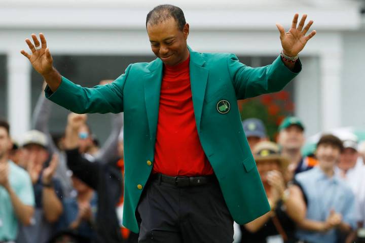 Tiger Woods smiles as he wears his green jacket after winning the Masters golf tournament Sunda ...