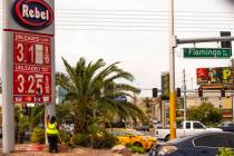 Rebel gas station asst. manager Michael Nunez puts up new gas prices at their station on E. Fla ...