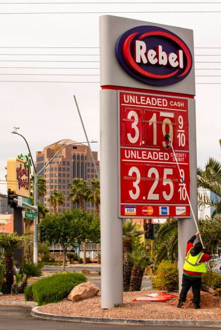 Rebel gas station asst. manager Michael Nunez puts up new gas prices at their station on E. Fla ...