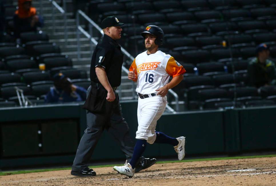 Las Vegas Aviators left fielder Mark Payton (16) scores a run against the Sacramento River Cats ...