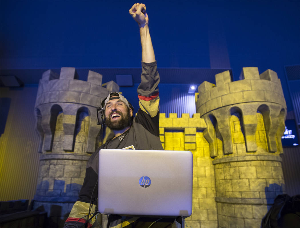 Golden Knights music director Jake Wagner waves to the crowd at the end of the first period dur ...