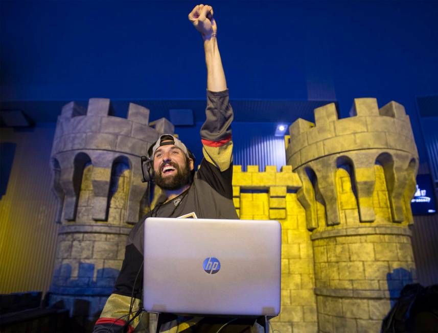 Golden Knights music director Jake Wagner waves to the crowd at the end of the first period dur ...