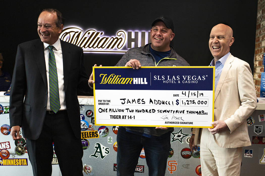 William Hill CEO Joe Asher, stands with big winner James Adducci of Wisconsin and SLS General M ...