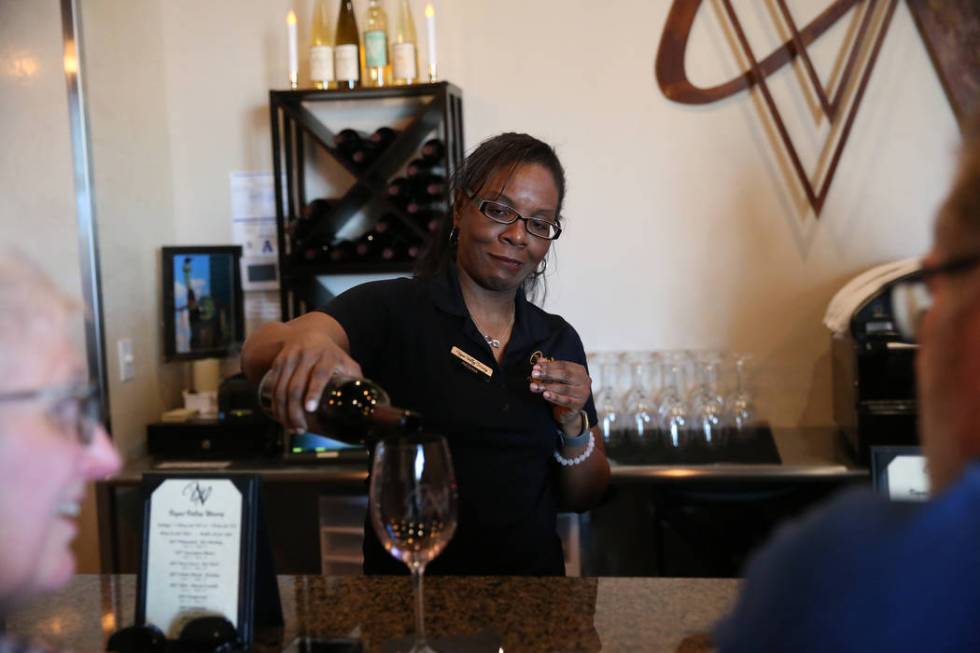 Winetender Regina Johnson pours a glass of wine for a customer at Vegas Valley Winery in Hender ...