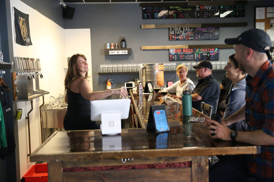 Office manager Amber Barkley, left, speaks with customers at Bad Beat Brewing in Henderson, Sat ...