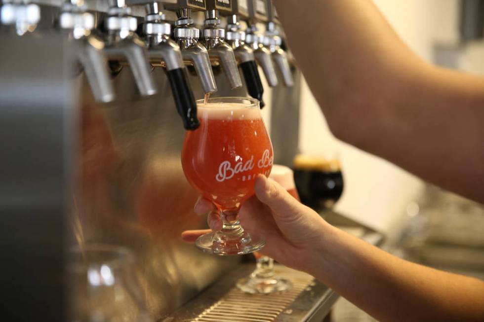 Office manager Amber Barkley pours a beer for a customer at Bad Beat Brewing in Henderson, Satu ...