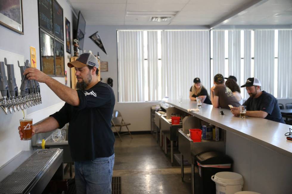 Allan Harrison, head brewer at Astronomy Ale Works, pours a glass of beer at Astronomy Ale Work ...