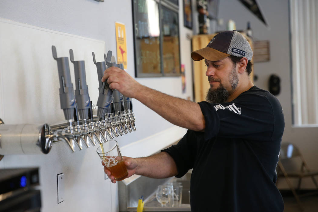 Allan Harrison, head brewer at Astronomy Ale Works, pours a glass of beer at Astronomy Ale Work ...