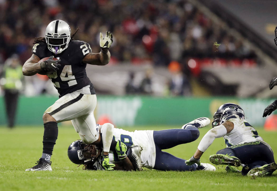 Oakland Raiders running back Marshawn Lynch (24) is tackled by Seattle Seahawks cornerback Shaq ...