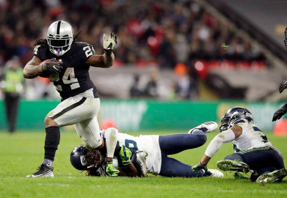 Oakland Raiders running back Marshawn Lynch (24) is tackled by Seattle Seahawks cornerback Shaq ...