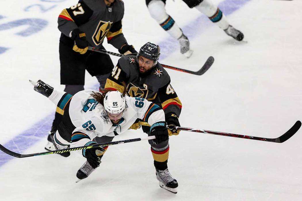 Vegas Golden Knights center Pierre-Edouard Bellemare (41) pushes San Jose Sharks defenseman Eri ...