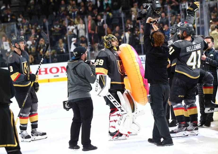 Golden Knights goaltender Marc-Andre Fleury (29) holds an inflatable donut after leading his te ...