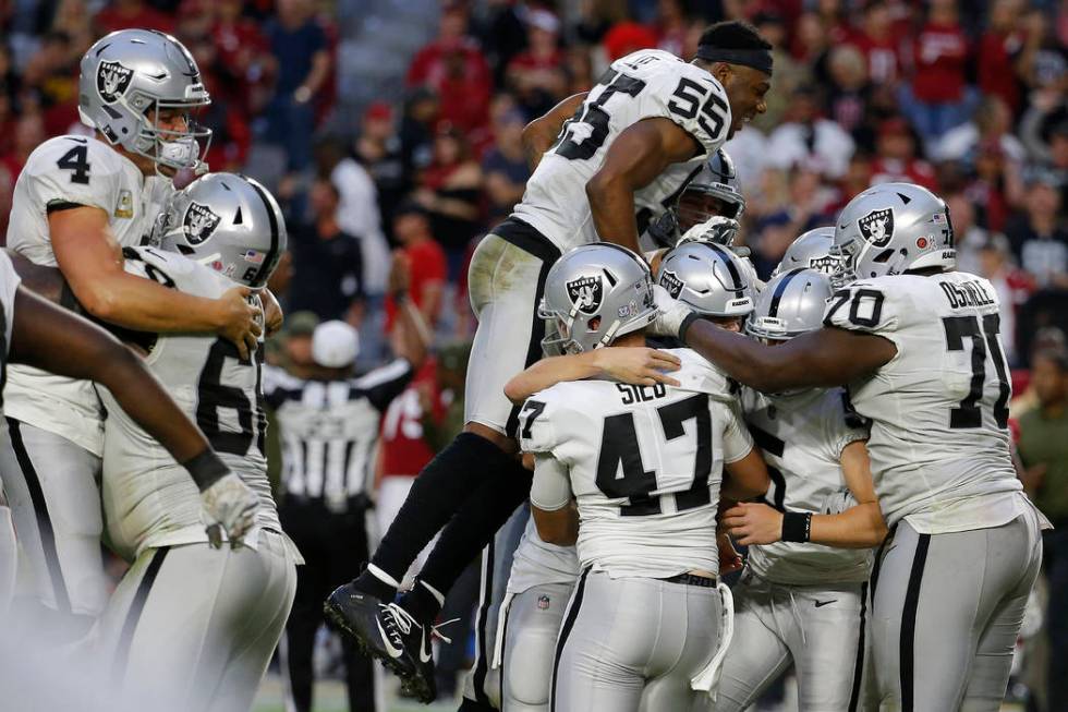 The Oakland Raiders celebrate as time expires during the second half of an NFL football game ag ...