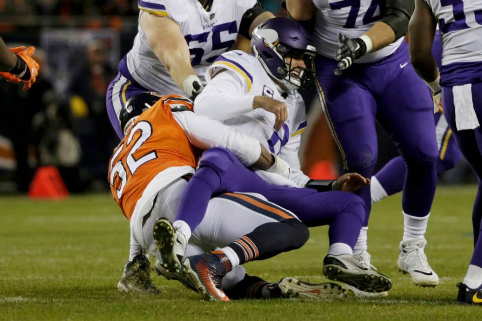 Minnesota Vikings quarterback Kirk Cousins (8) is tackled by Chicago Bears outside linebacker K ...