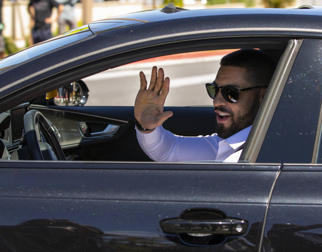 Golden Knights center Pierre-Edouard Bellemare smiles at fans while players depart City Nationa ...