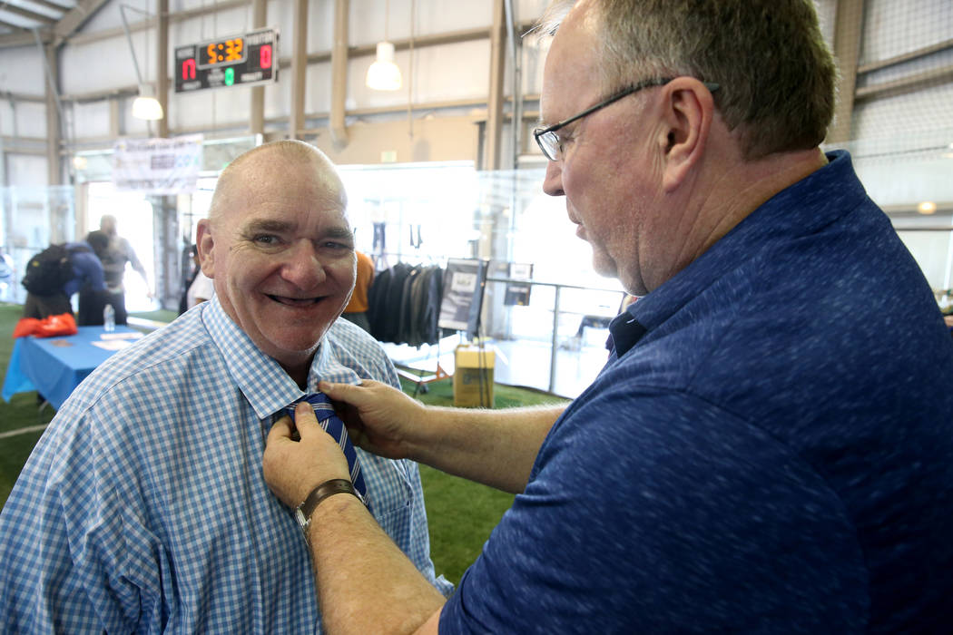 U.S. Marine Corps veteran Michael Mosley, 61, gets help with his tie from photographer Mikel Co ...