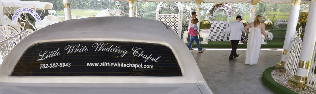 A couple heads into A Little White Wedding Chapel at 1301 S. Las Vegas Blvd. in Las Vegas on Th ...