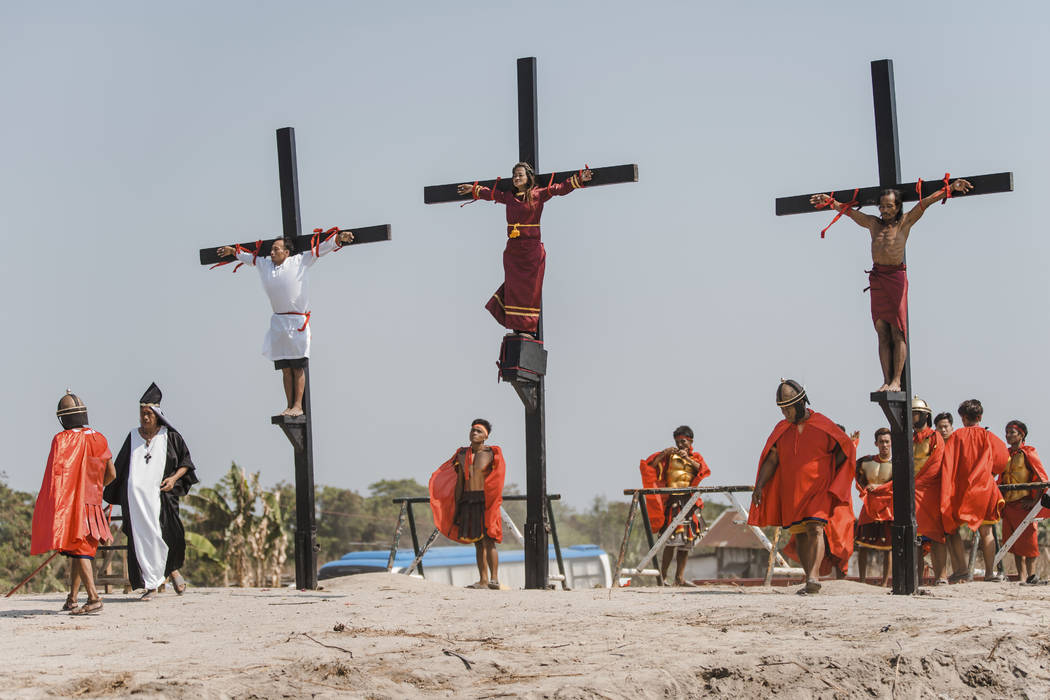 Three Filipino devotees are seen nailed on the cross as part of Good Friday rituals in the vill ...