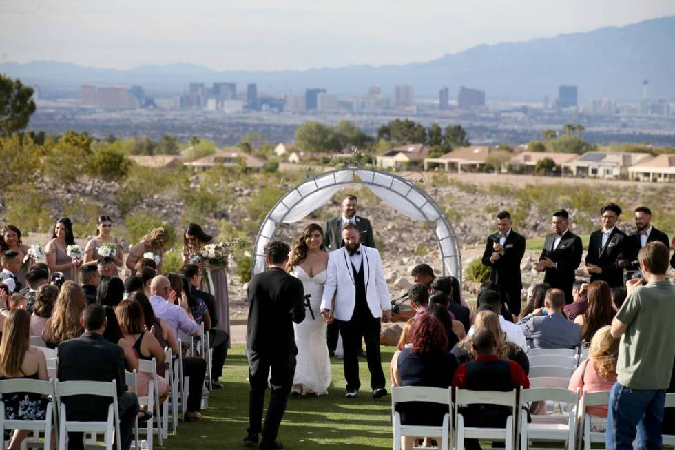 Kimberly and William King walk down the isle during their wedding ceremony at the Revere Golf C ...