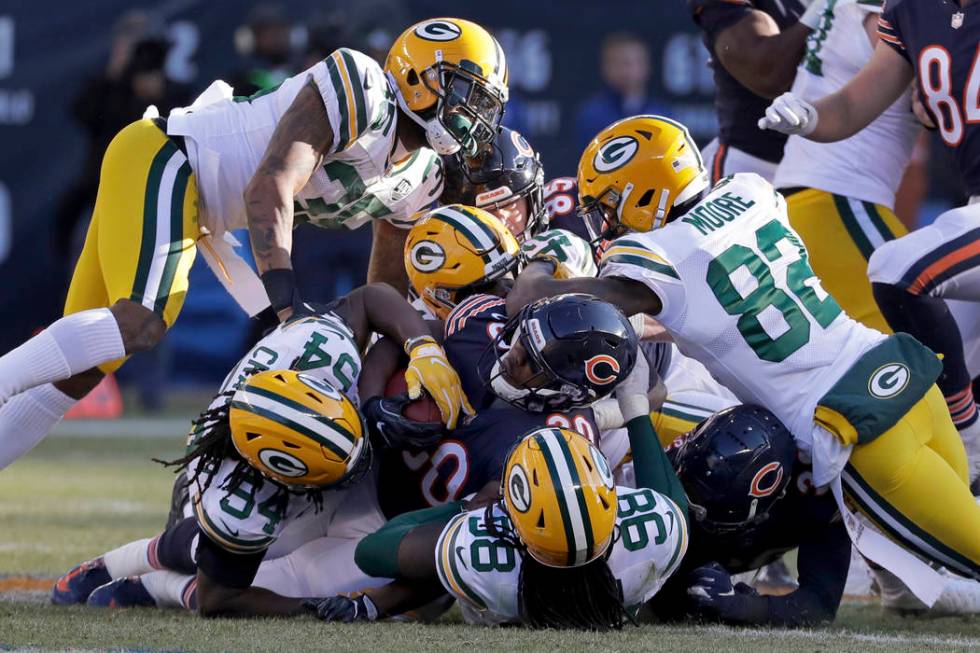 Chicago Bears running back Benny Cunningham (30) is tackled by Green Bay Packers defenders duri ...