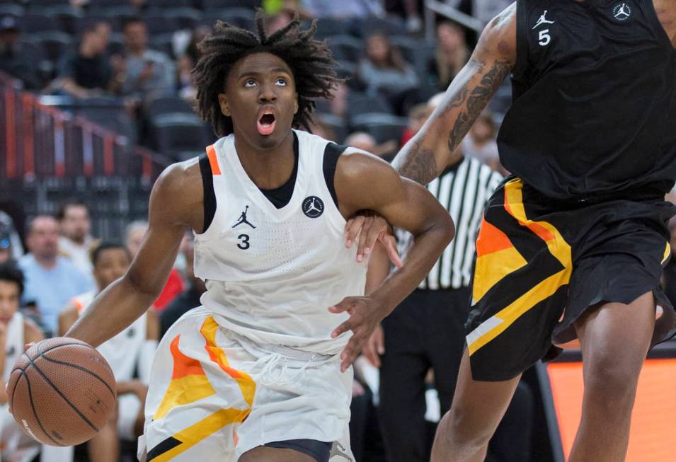 Tyrese Maxey (3) drives baseline past Armando Bacot Jr. (5) in the second half during the Jorda ...