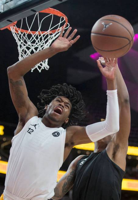 Keion Brooks (12) fights for a loose ball with Armando Bacot Jr. (5) in the second half during ...