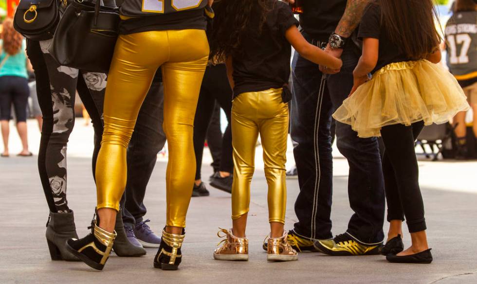 Fans wear all styles of gold clothing before the first period start of Game 6 of an NHL Western ...
