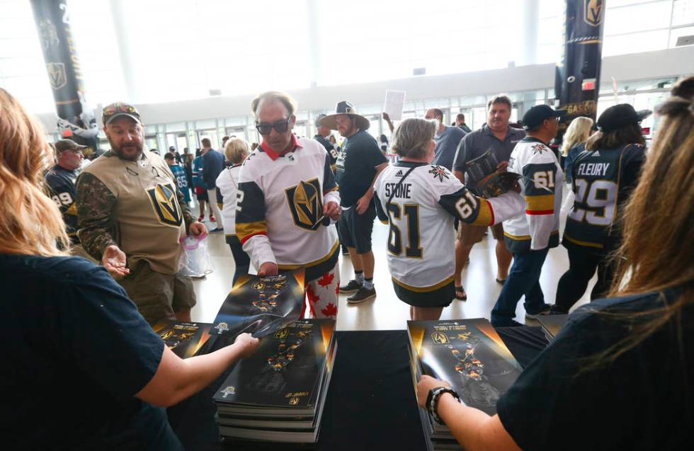 Golden Knights fans pickup gameday posters before the start of Game 6 of an NHL Western Confere ...